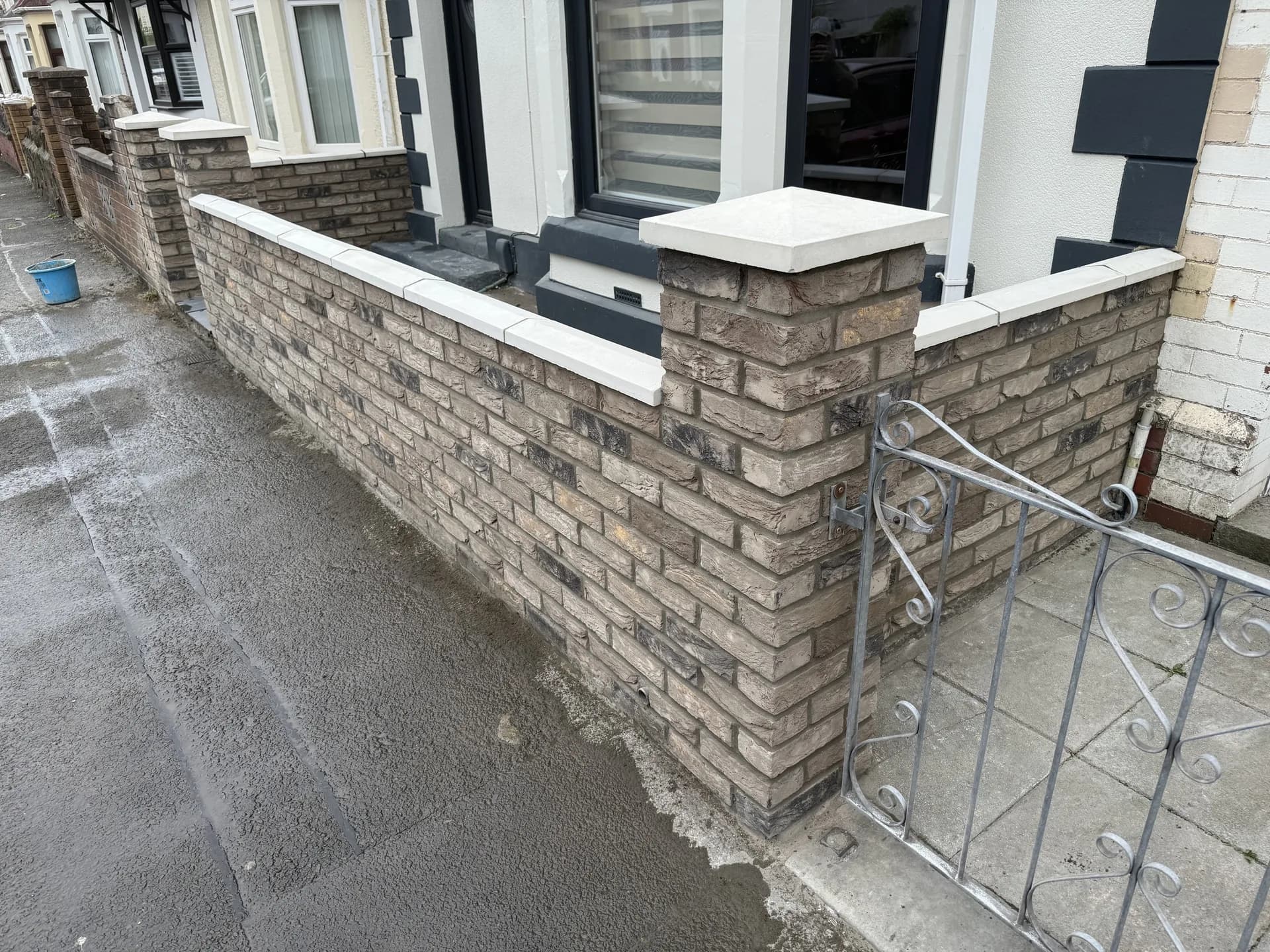 Front garden brick wall with metal gate by Reynolds Brickwork in Bridgend