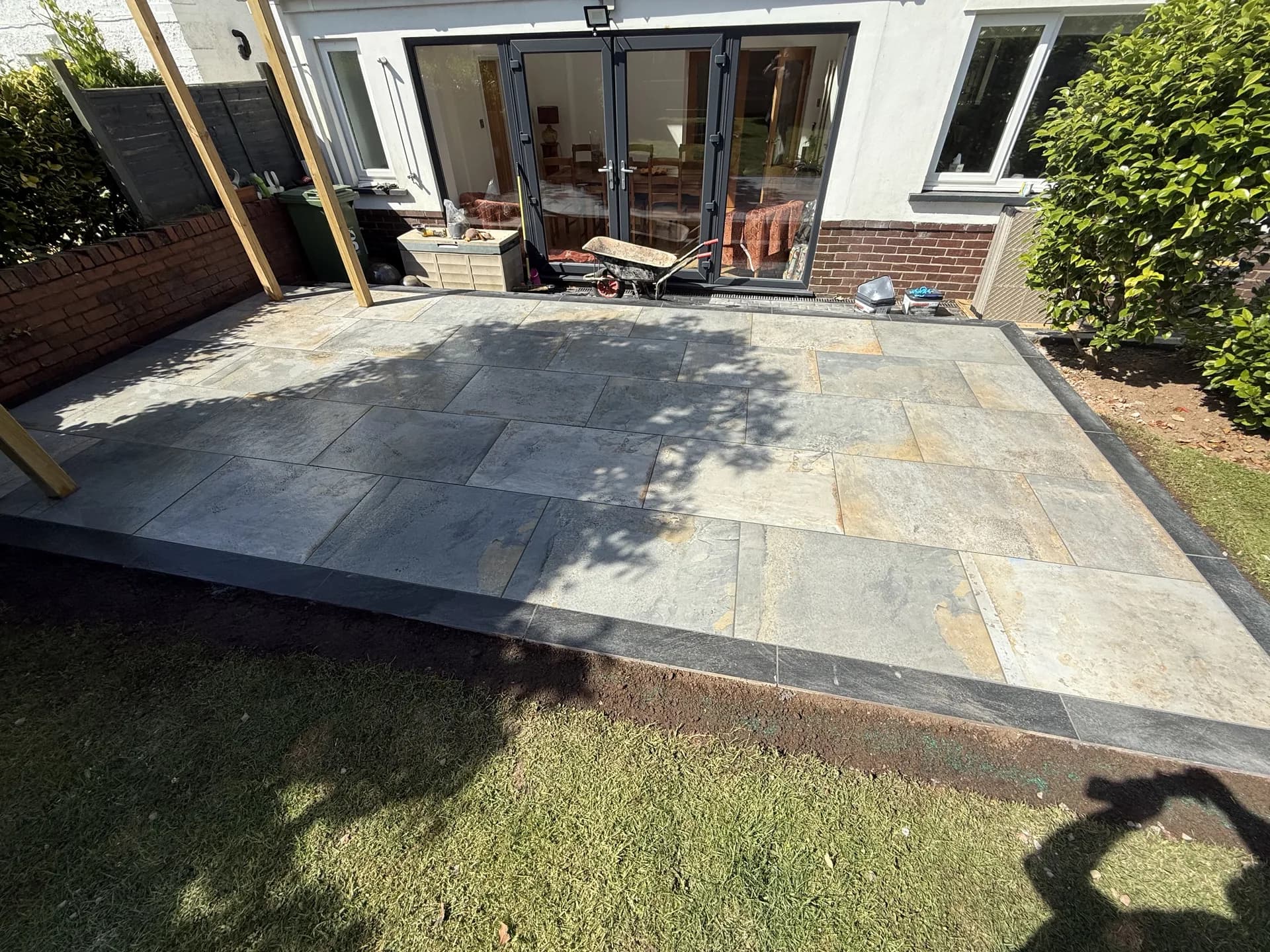 Indian stone patio with bifold doors by Reynolds Brickwork in Pencoed